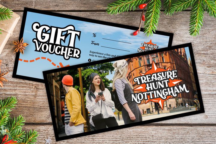 A gift voucher for Treasure Hunt Nottingham on a table covered with Christmas decorations