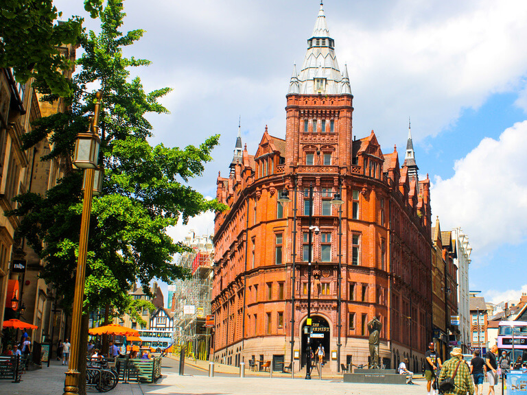 A beautiful red brick building with a central tower